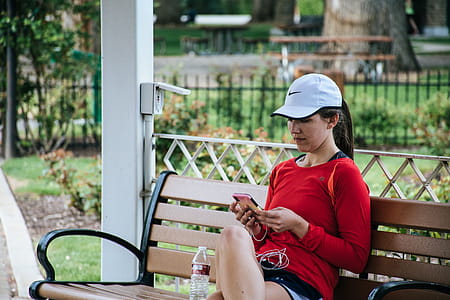 Woman In Red Long-sleeved Top Sitting On Bench thumbnail