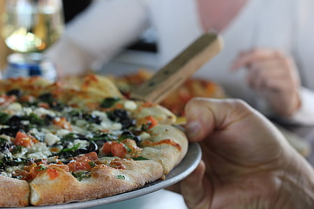 person holding plate with pizza on top thumbnail