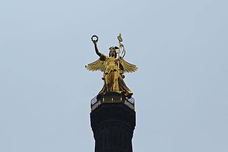gold statue of angel during daytime thumbnail