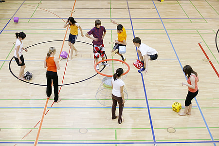 woman and man standing on brown basketball court thumbnail