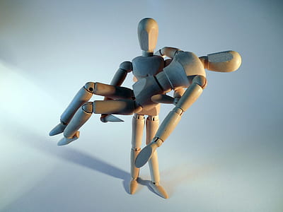 close-up of two brown puppet human toys thumbnail