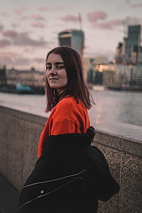 woman standing beside gray concrete railing thumbnail
