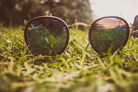 black sunglasses on green grass field thumbnail