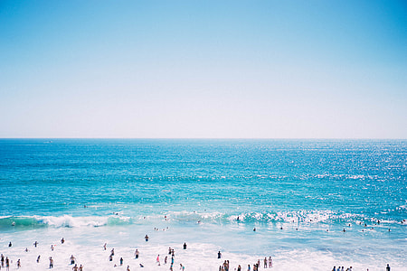 people swimming on the beach thumbnail