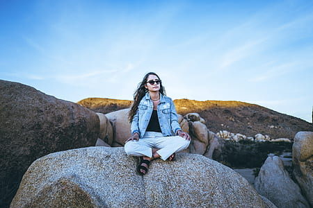 woman sitting on rock formation thumbnail