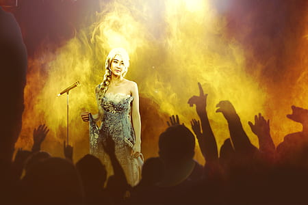 woman standing on stage painting thumbnail