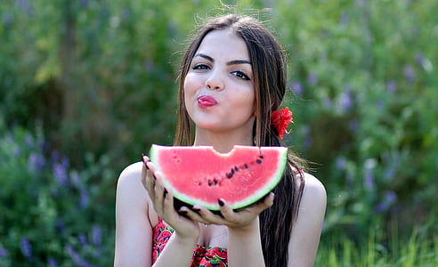 woman holding watermelon at daytime thumbnail