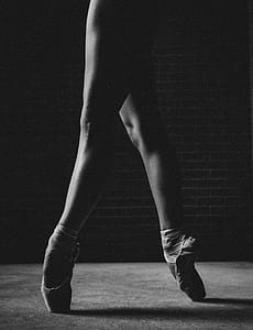 grayscale photo of ballerina tip toeing thumbnail