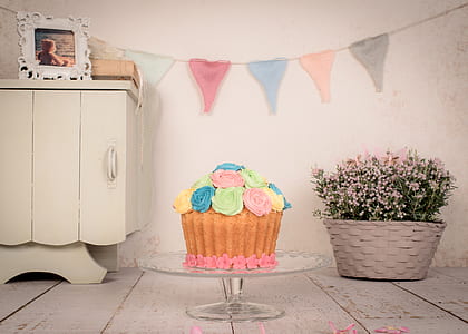 cake with icing on glass footed cake rack thumbnail