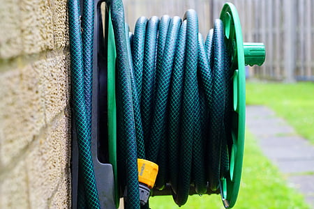 hose spool beside wall thumbnail