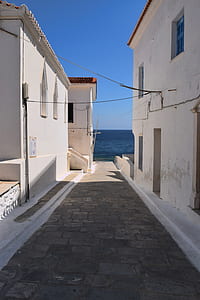 concrete alley near body of water thumbnail