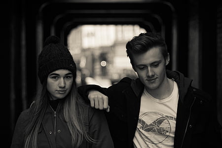 grayscale photography of woman beside man thumbnail