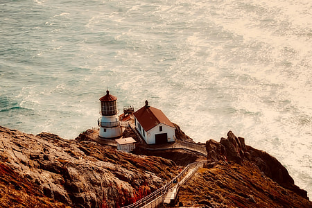 white and brown house on cliff near sea thumbnail