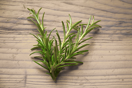 a green herb on a brown wooden surface thumbnail