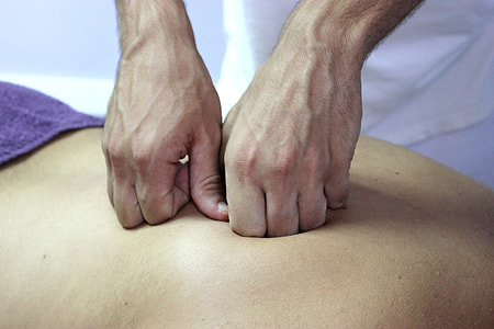 close-up photography of person massaging human back thumbnail