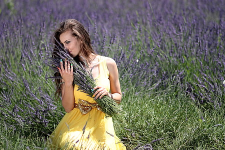 women's yellow square neckline sleeveless dress holding green bush thumbnail