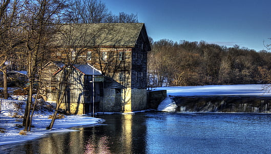 black 2-storey house beside body of water and trees during daytime thumbnail