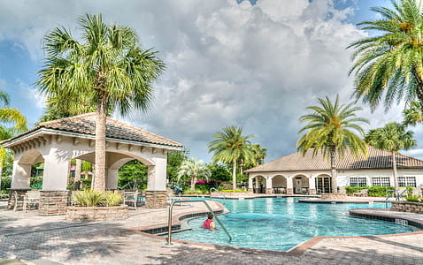man swimming on pool at daytime thumbnail