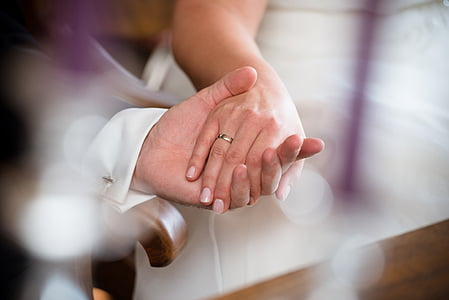 tilt lens photography of two people holding hands thumbnail