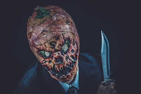 pumpkin head person holding knife thumbnail