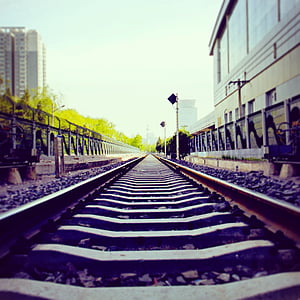train tracks near brown building thumbnail