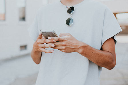 human holding silver iPhone photo thumbnail