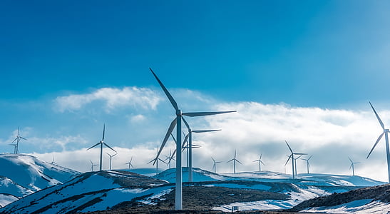 wind mills on snow covered ground during daytime thumbnail
