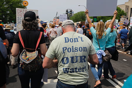 protesting crowd of people walking on road during daytime thumbnail