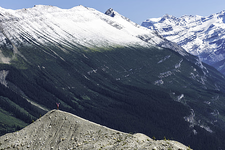 person on top of mountain rising his two hands thumbnail