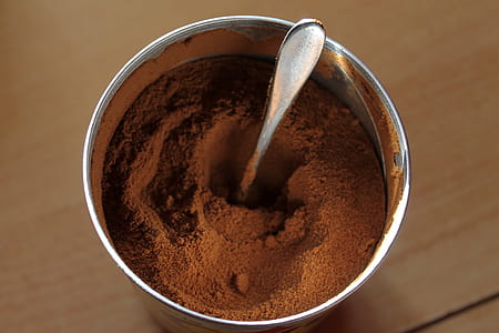 brown powder inside gray bowl with utensil thumbnail