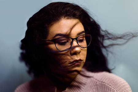 woman with brown shirt and black framed eyeglasses thumbnail