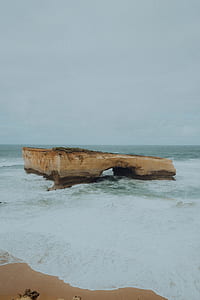 brown stone fragment near body of water thumbnail