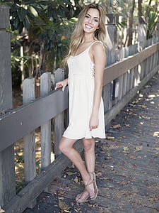 smiling woman wearing white spaghetti strap mini dress thumbnail