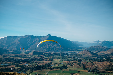 man doing paragliding during daytime thumbnail
