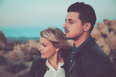 couple standing beside each other near rock formations thumbnail