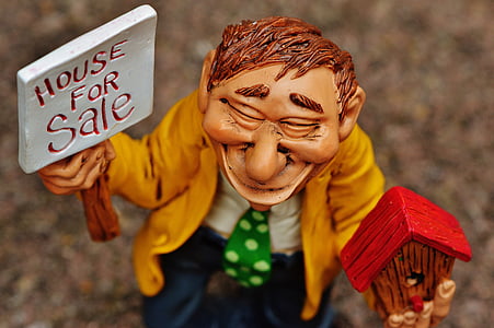 man holding house for sale figurine thumbnail