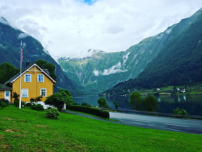 brown and black house beside the road with landscape background thumbnail