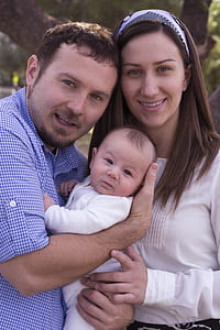 man carrying baby beside woman thumbnail