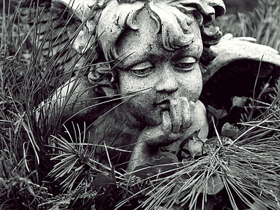 gray cherub on grass photo thumbnail