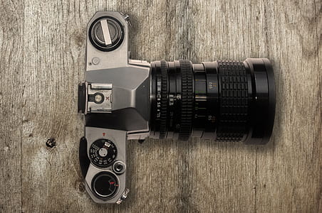 black camera on brown wooden table thumbnail