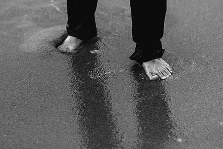 person walking sand with water thumbnail