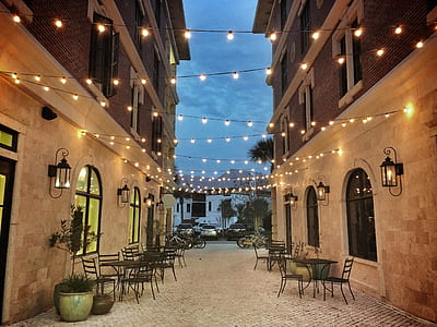 dining sets by the street under lighted string lights thumbnail
