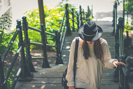 woman in gray long-sleeve top and black hat thumbnail