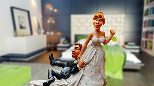 bride dragging groom ceramic figurine in selective focus photography thumbnail