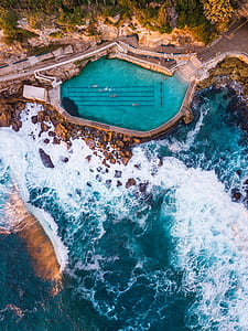 aerial photography of pool beside cliff thumbnail
