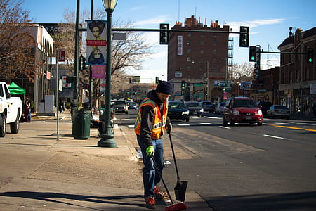 man standing beside road during daytime thumbnail