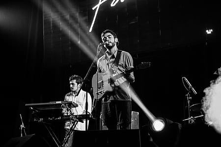 person performing on stage grascale photo thumbnail