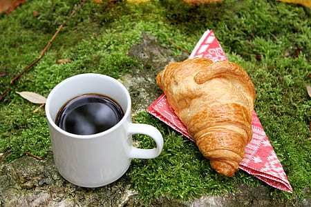 white ceramic mug beside croissant thumbnail