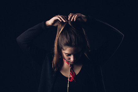 woman tying her hair thumbnail
