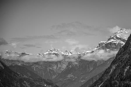 Snow Covered Rugged Mountain With Mist Photograph thumbnail
